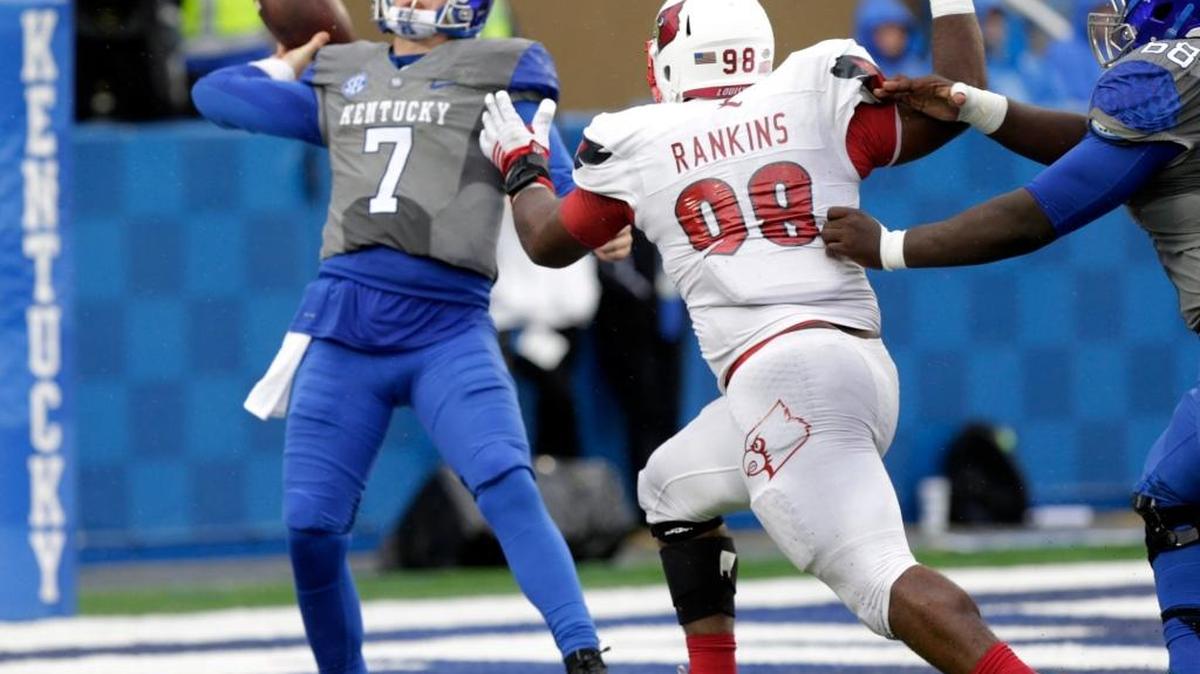 Kentucky quarterback Drew Barker (7) threw under pressure from Louisville defensive end Sheldon Rankins (98) in last November’s UK-U of L game at Commonwealth Stadium. This spring, Barker is learning his third offense in as many years since coming to Kentucky.