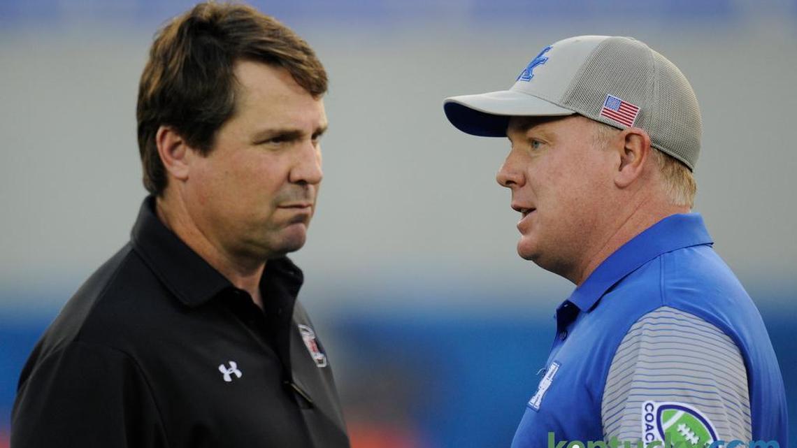 Kentucky Coach Mark Stoops, right, has led the Wildcats to four-straight victories over South Carolina. Stoops talked with Gamecocks head man Will Muschamp before the 2016 meeting between the teams in Lexington.