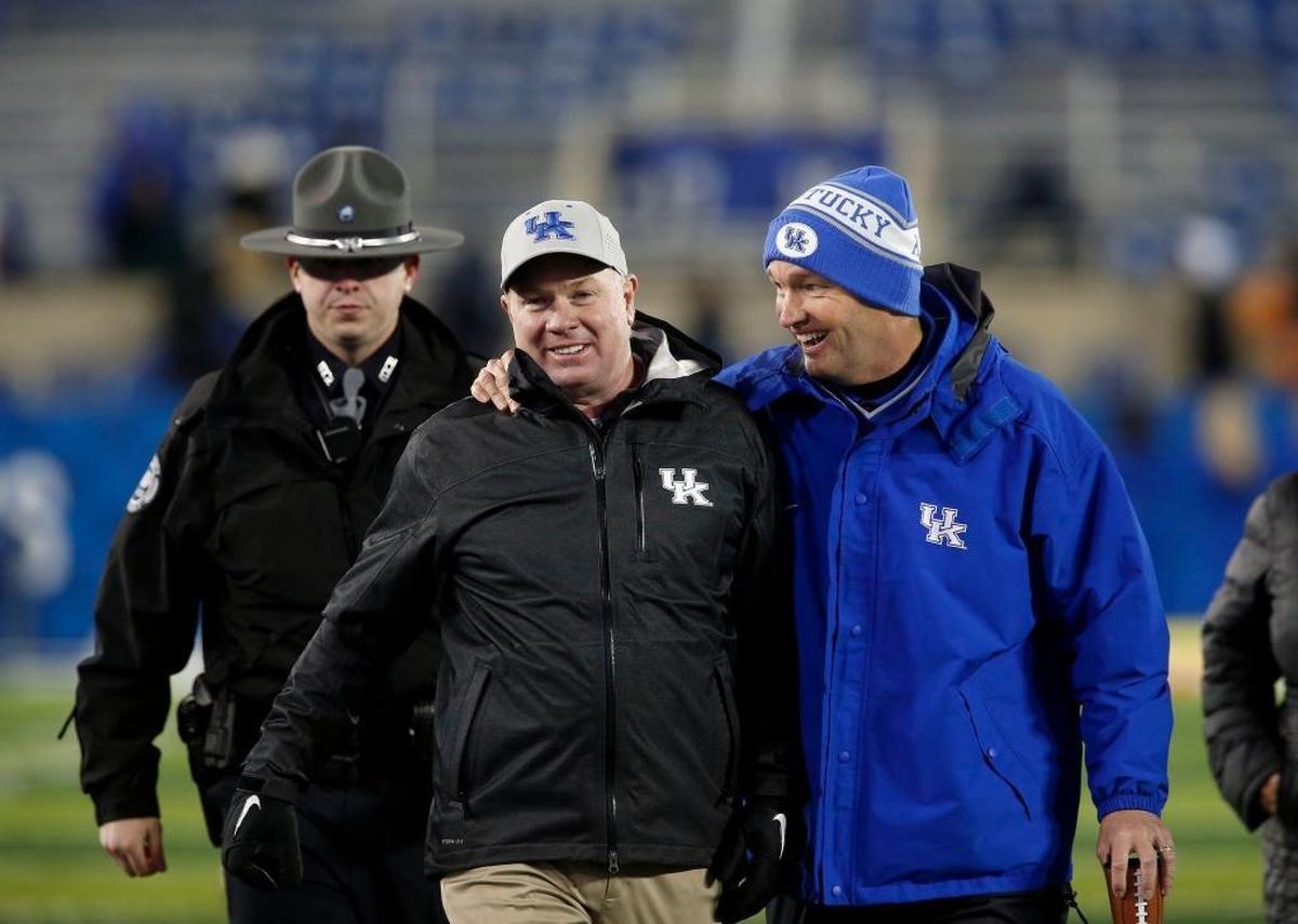 UK Athletics Director Mitch Barnhart, right, and the rest of the Kentucky administration stood by Wildcats football coach Mark Stoops, center, during some lean early years and have since been rewarded with four straight winning seasons and back-to-back bowl victories.