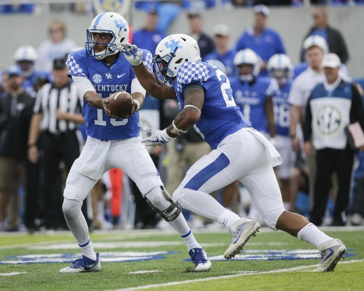Kentucky quarterback Stephen Johnson handed off the ball to Benny Snell Jr. during the first half against Mississippi Saturday, Nov. 4, 2017, in Lexington, Ky. (AP Photo/David Stephenson)