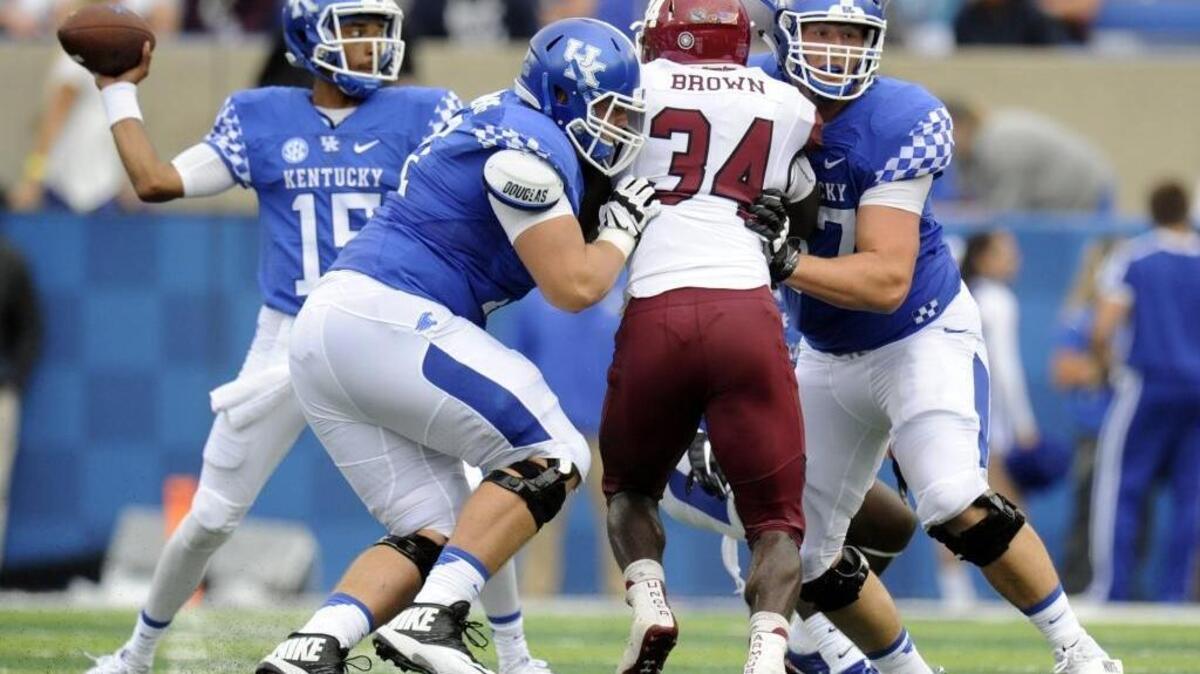 Left guard Logan Stenberg and left tackle Landon Young, right, blocked for quarterback Stephen Johnson during Kentucky’s 62-42 victory over New Mexico State this season.