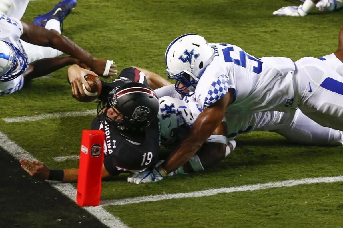 Kentucky linebacker Courtney Love (51) and safety Mike Edwards (7) stopped South Carolina quarterback Jake Bentley (19) short of a touchdown during their game at Williams-Brice Stadium in Columbia, S.C., last Saturday.