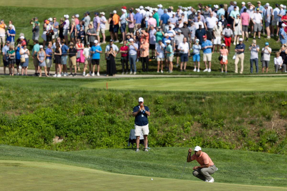 Tiger Woods shot a 1-over-par 72 on Thursday and trails front-runner Xander Schauffele by 10 shots.