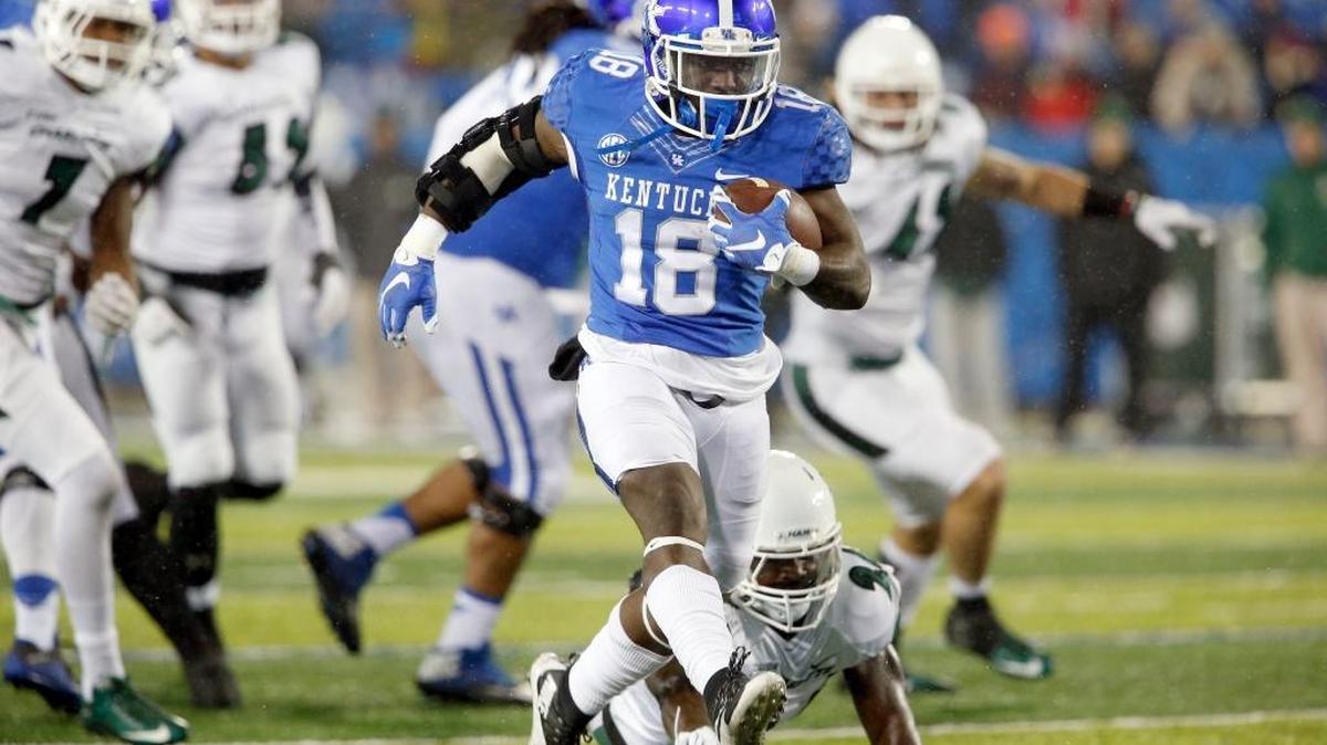 Kentucky running back Boom Williams (18) eluded Charlotte linebacker Daquan Lucas (24) on his first touchdown run on Nov. 21, 2015.