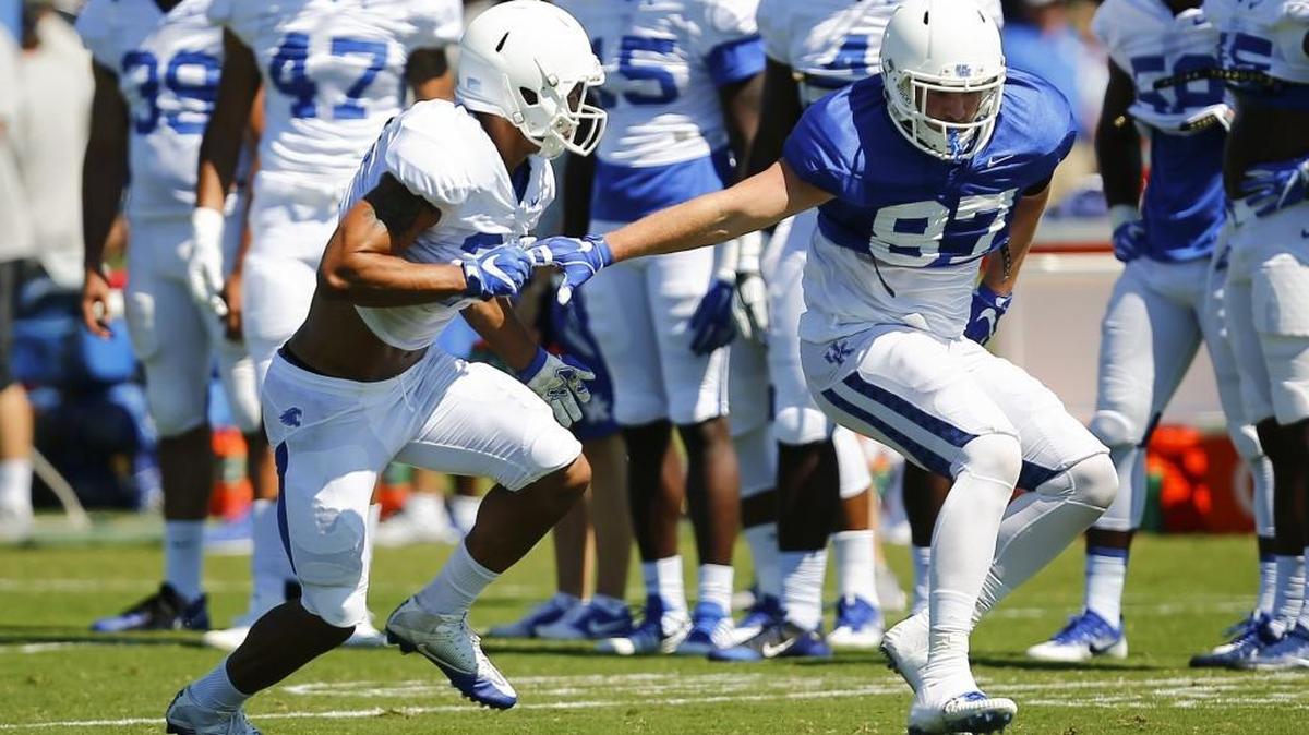 C.J. Conrad, right, worked against linebacker Jordan Jones during practice Saturday.