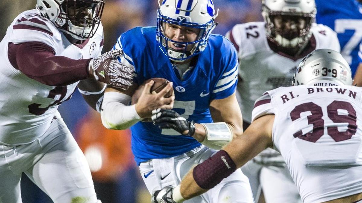 BYU quarterback Taysom Hill (7) ran past Mississippi State defensive lineman Cory Thomas (34) and linebacker Richie Brown (39) during the Cougars’ overtime victory over MSU on Friday night. Mississippi State visits Commonwealth Stadium on Oct. 22.