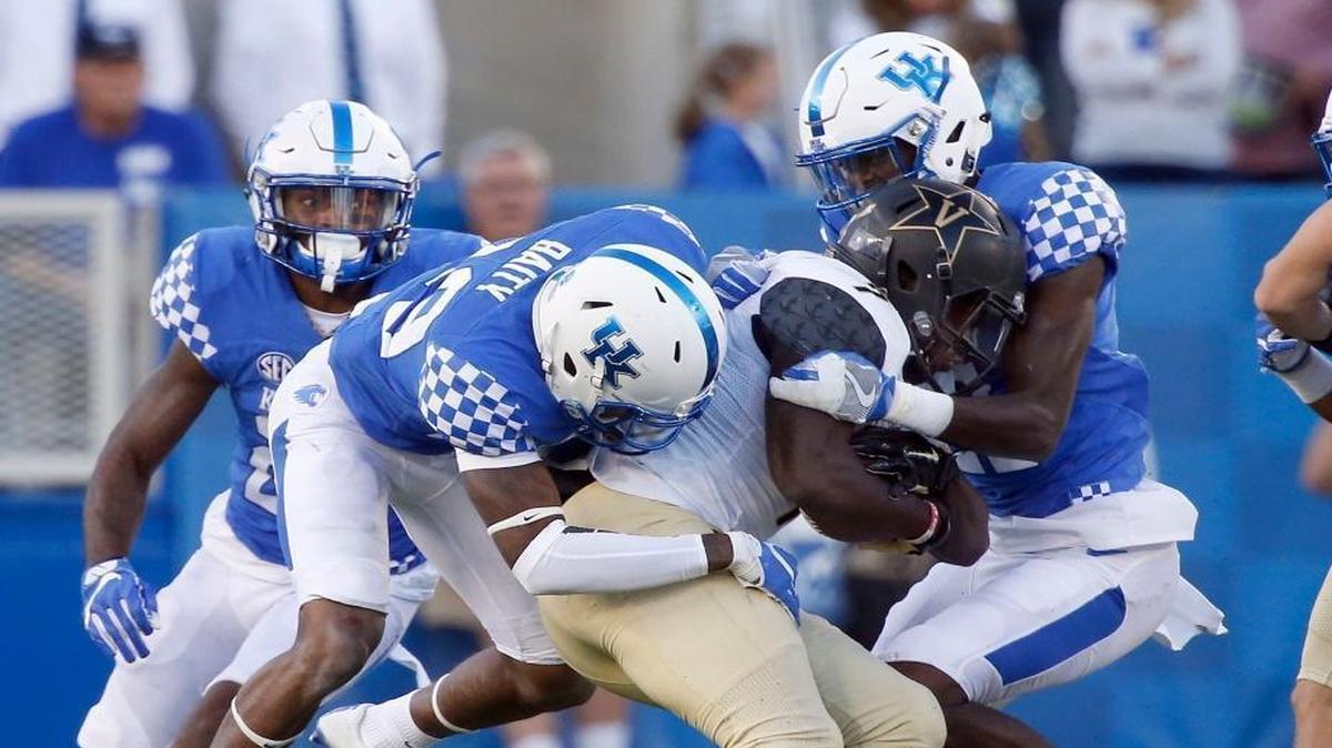 Kentucky cornerbacks Derrick Baity (29) and Chris Westry, right, combined to tackle Vanderbilt running back Ralph Webb (7) at Commonwealth Stadium on Oct. 8, 2016. UK won 20-13.