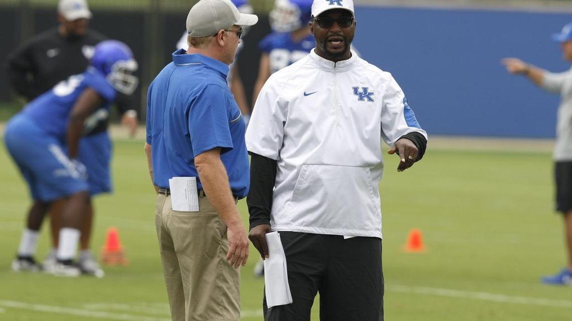 Head football coach Mark Stoops chats with defensive backs coach Steve Clinkscale during an open practice for UK Football Fan Day on the new practice fields in Lexington, Ky., Saturday, August 6, 2016.