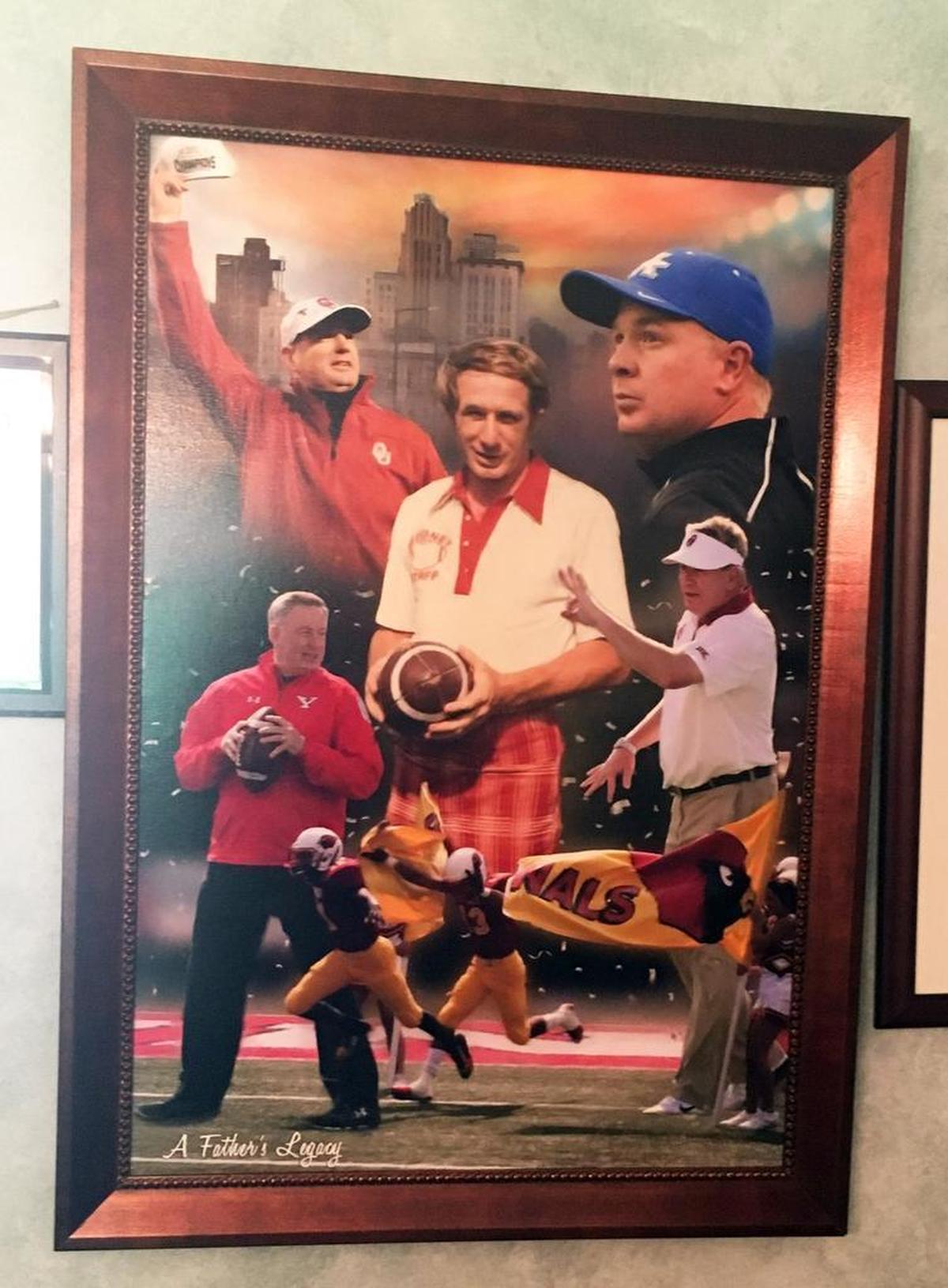 This original artwork titled “A Father’s Legacy” was commissioned recently for a United Way charity event. It features Ron Stoops surrounded by all four of his college coaching sons: Bob Stoops (Oklahoma), Mark Stoops (Kentucky), Mike Stoops (Oklahoma) and Ron Stoops Jr. (Youngstown State). A copy of the print hangs in Dee Stoops’ home.