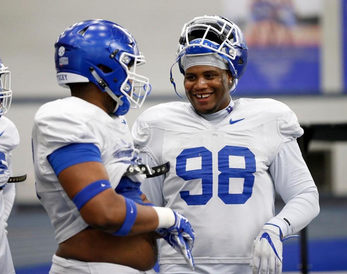 Kentucky Wildcats defensive tackle Tymere Dubose, right, joked with teammate Phil Hoskins, left, at practice this spring. Both Hoskins and Dubose are expected to add some much needed depth to the Cats’ line.