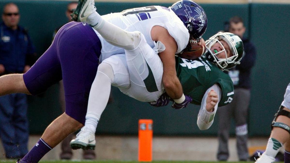 Northwestern's Joe Gaziano, left, sacked Michigan State quarterback Brian Lewerke for a safety last weekend.