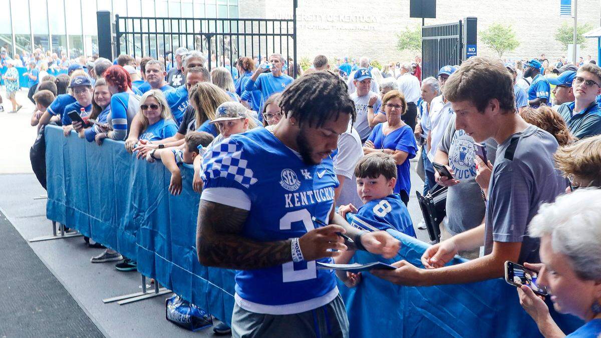 Suspended Kentucky Wildcats running back Chris Rodriguez (24) signs autographs for fans before the Wildcats’ season opener against Miami (Ohio). Rodriguez is eligible to return to the UK lineup on Oct. 1.
