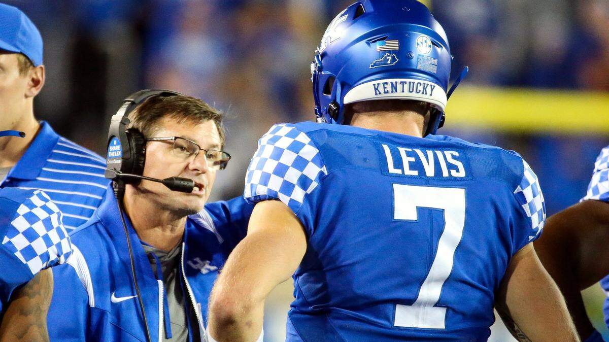 Kentucky ranks 14th out of 14 SEC teams in total offense and 11th out of 14 in points per game under the direction of offensive coordinator Rich Scangarello, left.