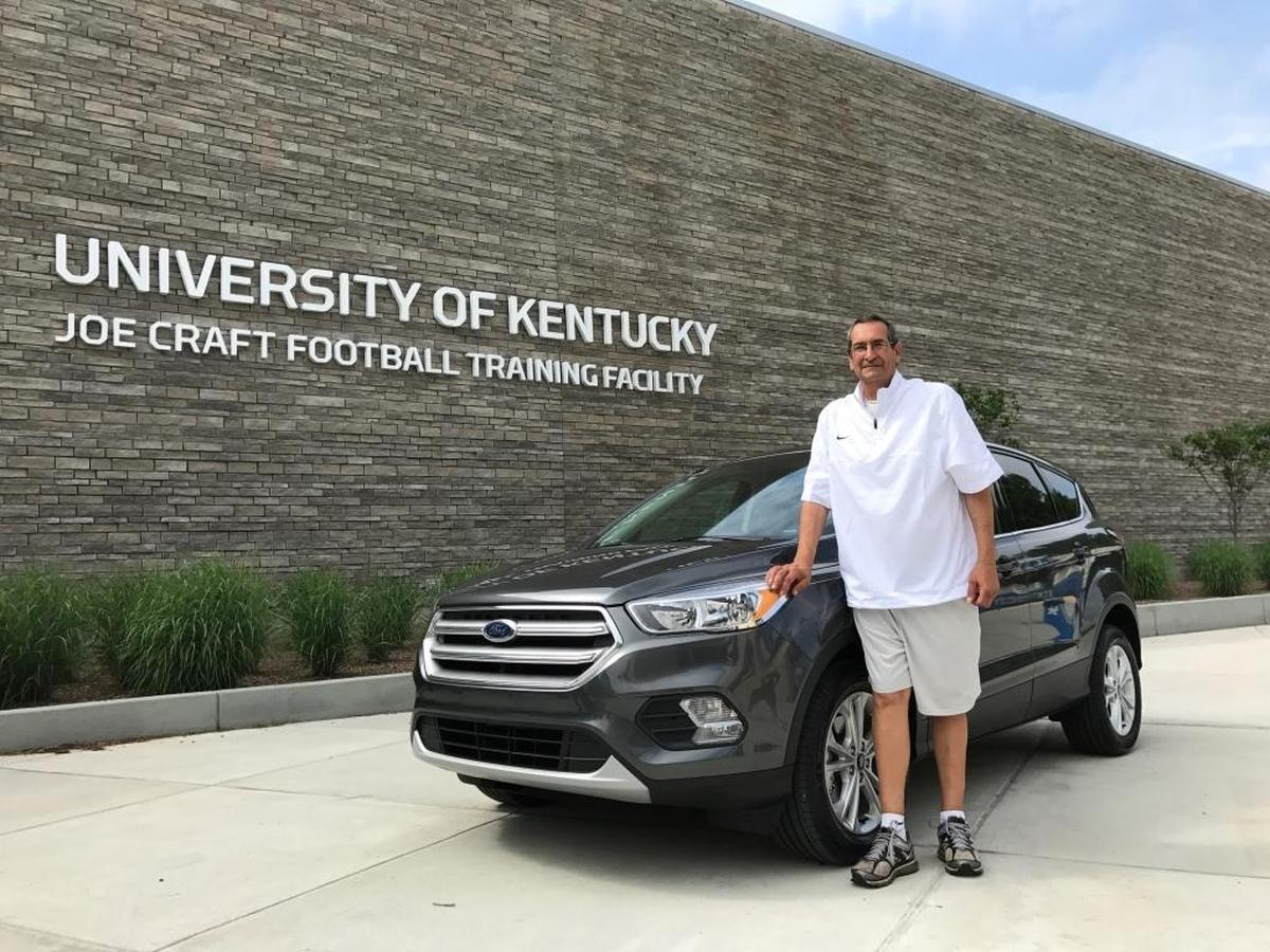 Longtime Kentucky football equipment manager Tom Kalinowski was surprised last month with a new Ford Escape. Many former players as well as coaches and staff members chipped in to get him the new vehicle.