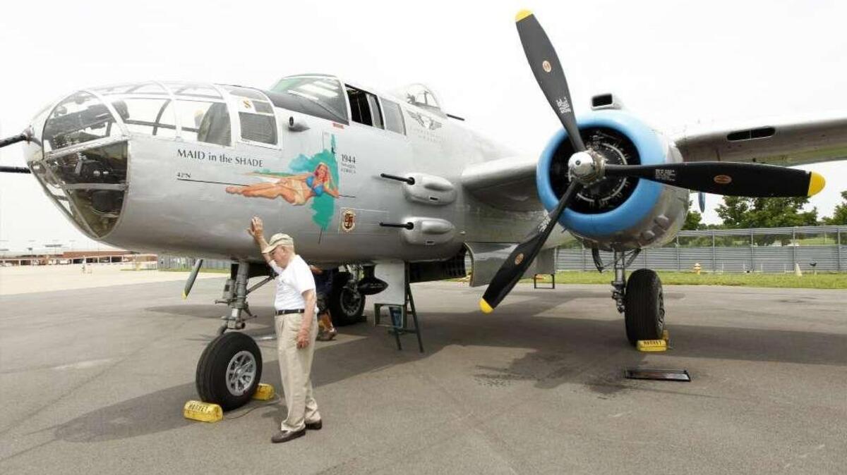 Jim Brown in 2013 with a B-25 bomber - the type of plane Brown served on as a navigator as one of the famed “Burma Bridge Busters” during World War II.