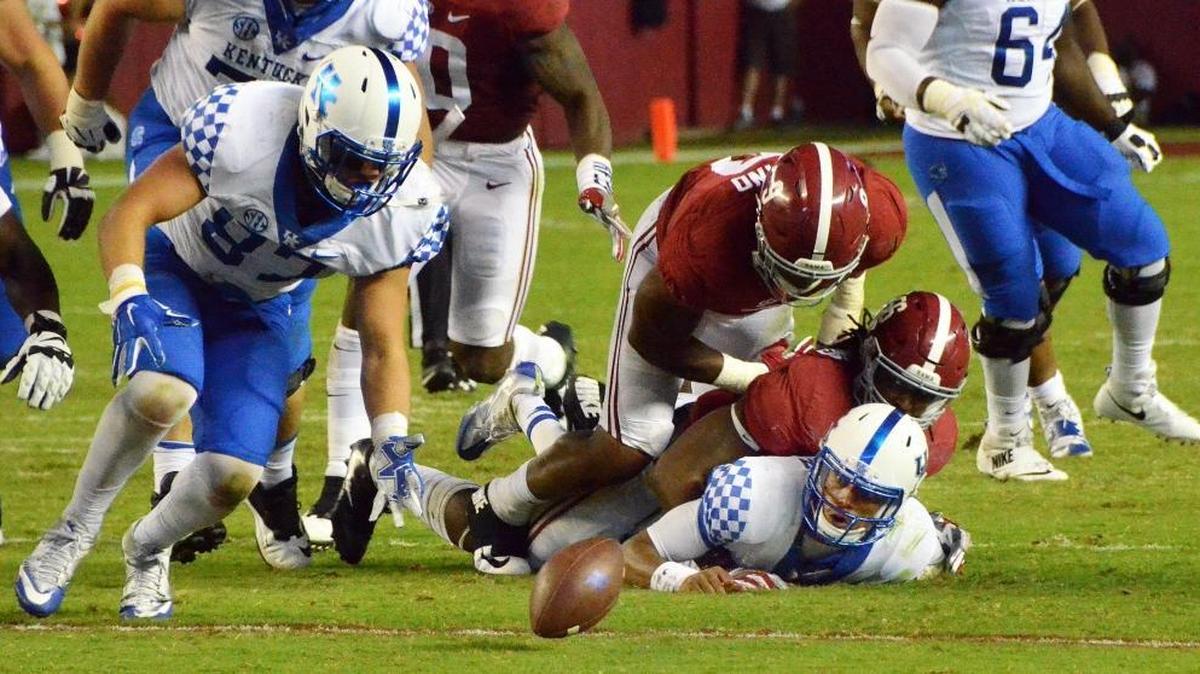 Kentucky quarterback Stephen Johnson fumbles the ball under pressure from Alabama's Tim Williams and Da'Shawn Hand in the third quarter as Kentucky played Alabama Alabama, Oct. 1, 2016 in Tuscaloosa. Kentucky's C.J. Conrad, left recovered the fumble. Photo by Brian Simms