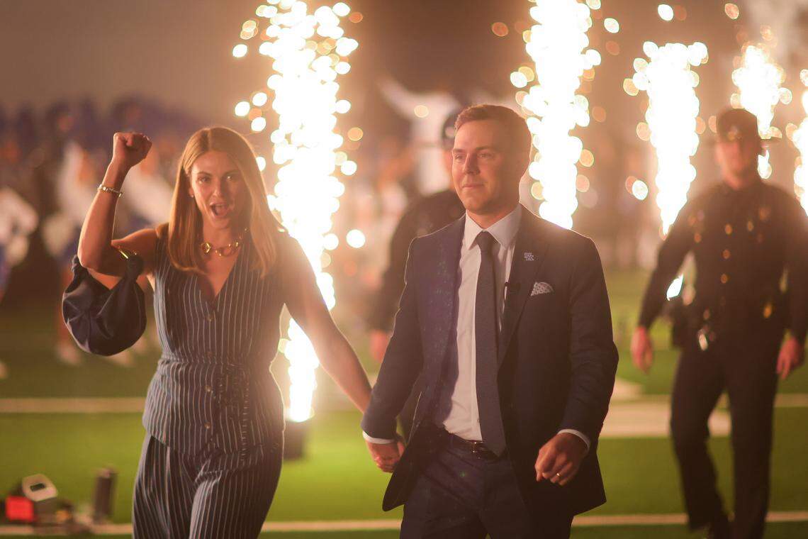 New Kentucky football coach Will Stein, right, and his wife, Darby, arrive at his introductory news conference Wednesday, Dec. 3, at Nutter Field House.