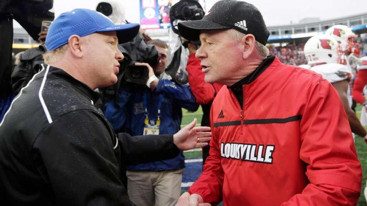 Mark Stoops, left, shook hands with Bobby Petrino after Kentucky lost to Louisville 38-24 in Commonwealth Stadium in the 2015 regular season finale.