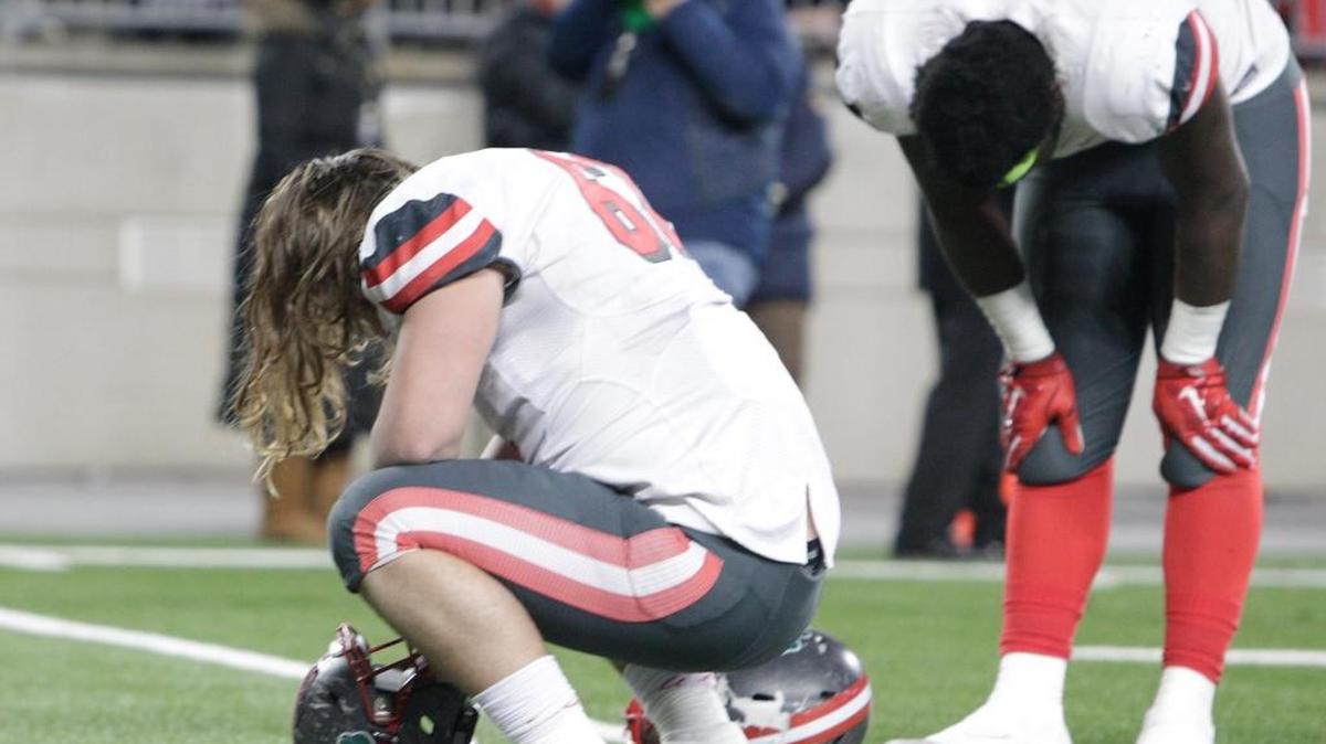 Toledo Central Catholic’s James Hudson, right, reacted after the team’s loss to Akron Archbishop Hoban in the Ohio Division II championship game last December.