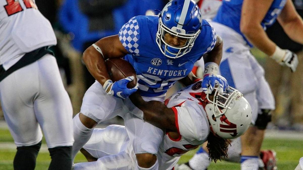 Kentucky running back Benny Snell, center, ran over Austin Peay defensive back Juantarious Bryant last season. The sophomore-to-be figures to have an increased workload next season.