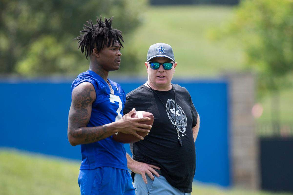 Kentucky Wildcats head coach Mark Stoops talks with wide receiver Barion Brown (7) during Kentucky football annual Fan Day open practice at Joe Craft Football Training Center practice fields in Lexington, Ky, Saturday, August 5, 2023.
