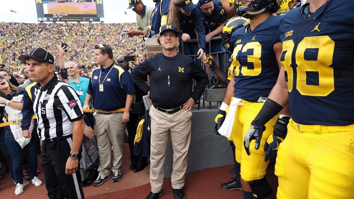 FILE - In this Oct. 1, 2016, file photo, Michigan coach Jim Harbaugh, center, waits to take the field with his players before an NCAA college football game against Wisconsin at Michigan Stadium in Ann Arbor, Mich. Michigan faces Maryland on Saturday.