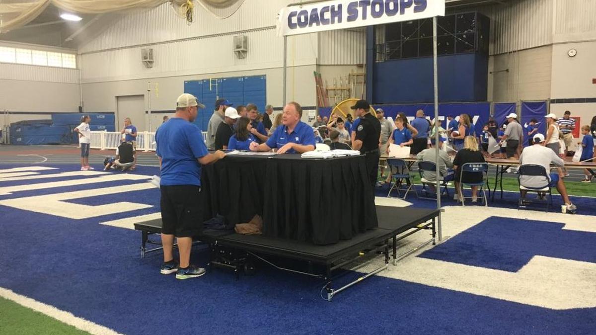 A long line wound behind Mark Stoops waiting to meet the UK head coach during Fan Day activities on Saturday.