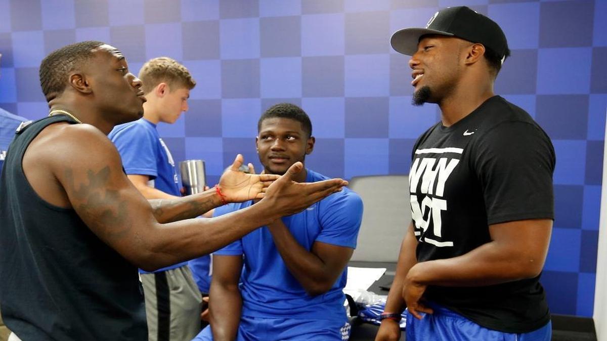 Boom Williams, left, Miles Butler, Alex Montgomery and Ryan Timmons joked around at the new University of Kentucky Football Training Center in Lexington on Aug. 4.