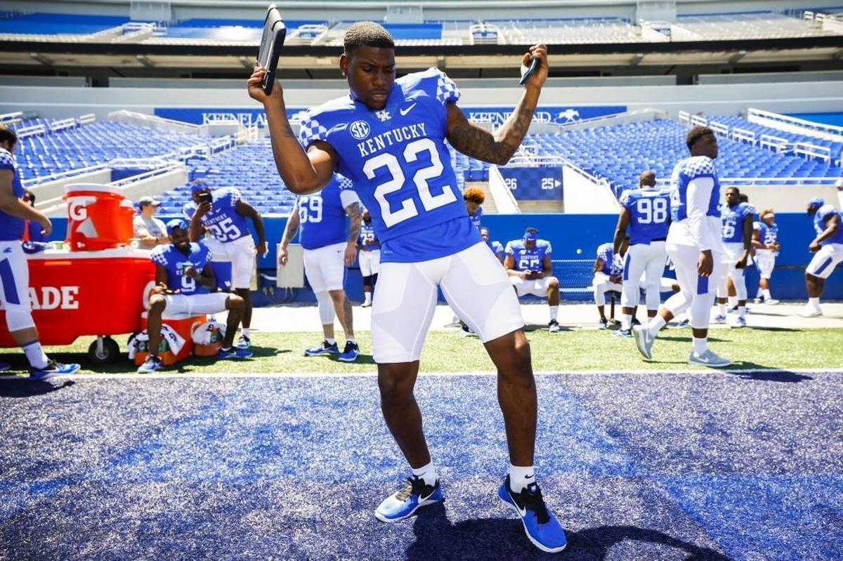 Kentucky running back Sihiem King dances along with a song on his iPad during media day at Kroger Field in Lexington on July 30.