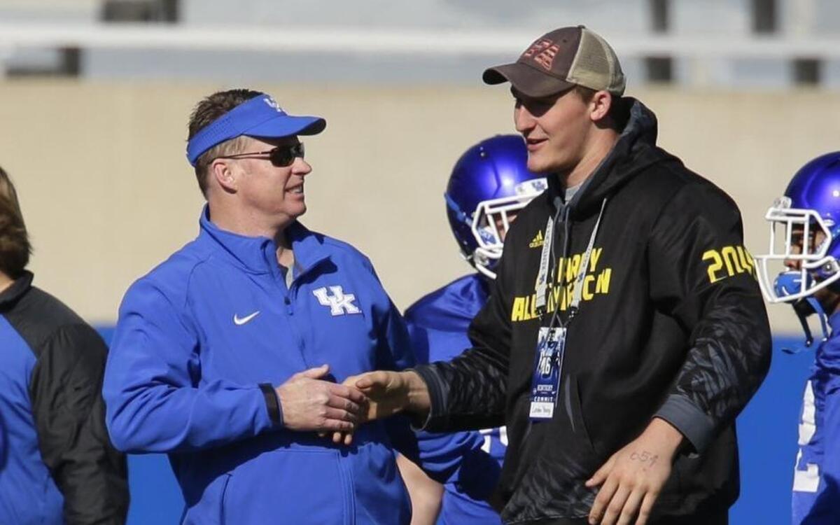 UK quarterbacks coach Darin Hinshaw, left, talked with five-star signee Landon Young during spring football practice in March.
