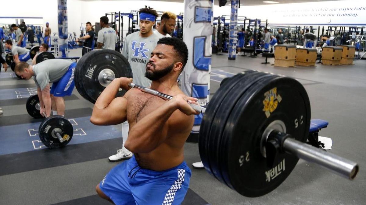 Linebacker Courtney Love lifted in front of defensive back Kendall Randolph as part of Kentucky’s football team took part in a weightlifting session on Feb. 26.