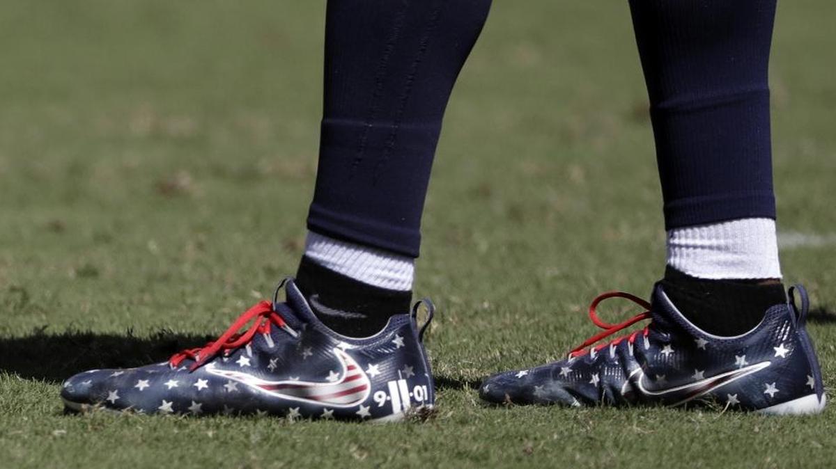 Tennessee Titans linebacker Avery Williamson wears shoes honoring victims of the 9/11 attacks in the second half of an NFL football game against the Minnesota Vikings Sunday, Sept. 11, 2016, in Nashville, Tenn.