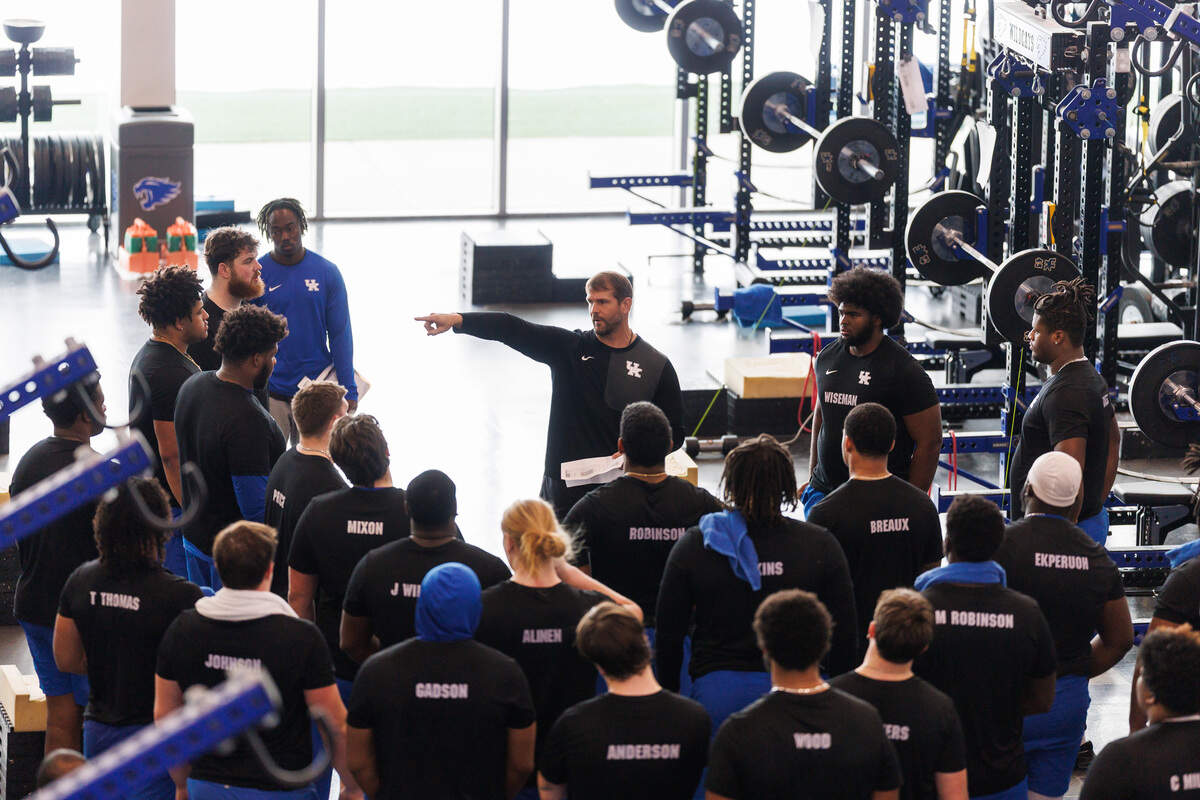 Brandon Roberts, Kentucky’s director of football sports performance, addresses the Wildcats in the weight room at the Joe Craft Football Training Facility.