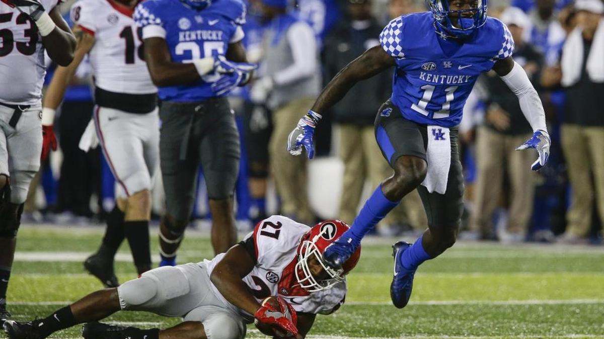 Kentucky Wildcats cornerback J.D. Harmon (11) celebrates after throwing Georgia Bulldogs running back Nick Chubb (27) for a loss as Kentucy played Georgia on Saturday November 5, 2016 in Lexington, Ky.