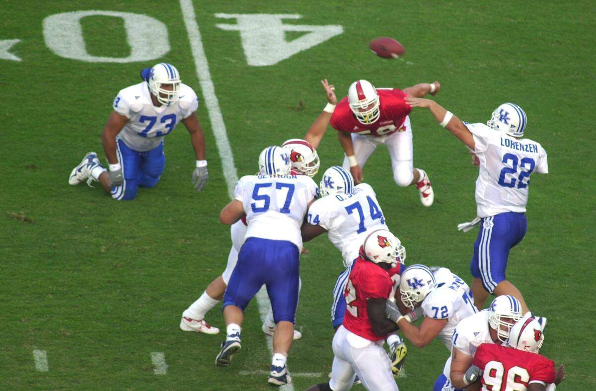 Kentucky quarterback Jared Lorenzen lets fly with his first career touchdown pass early in the first quarter of the UK-U of L game in 2000 in Louisville.