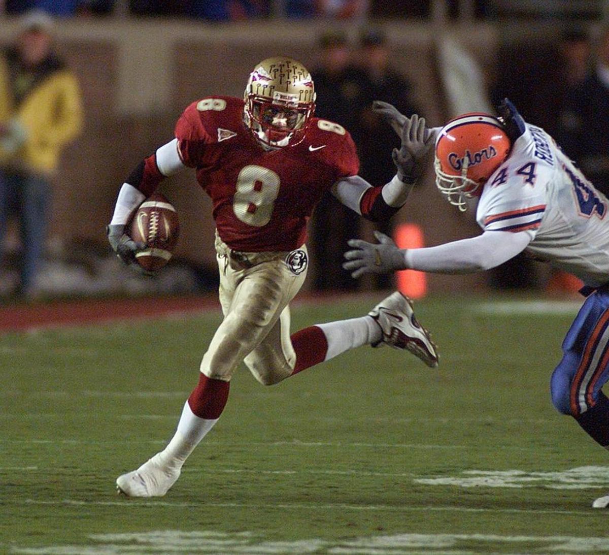 Florida State’s Clevan Thomas fended off Florida defender Rob Roberts during a game on Nov. 18, 2000.