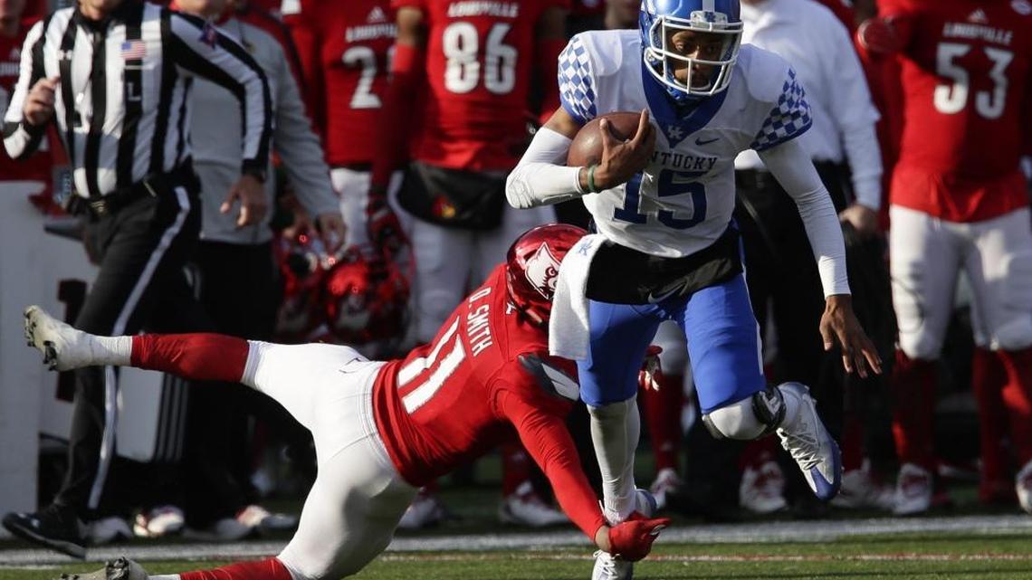 Kentucky quarterback Stephen Johnson passed for a career-high 338 yards and three touchdowns while running eight times for 83 yards against Louisville on Saturday.
