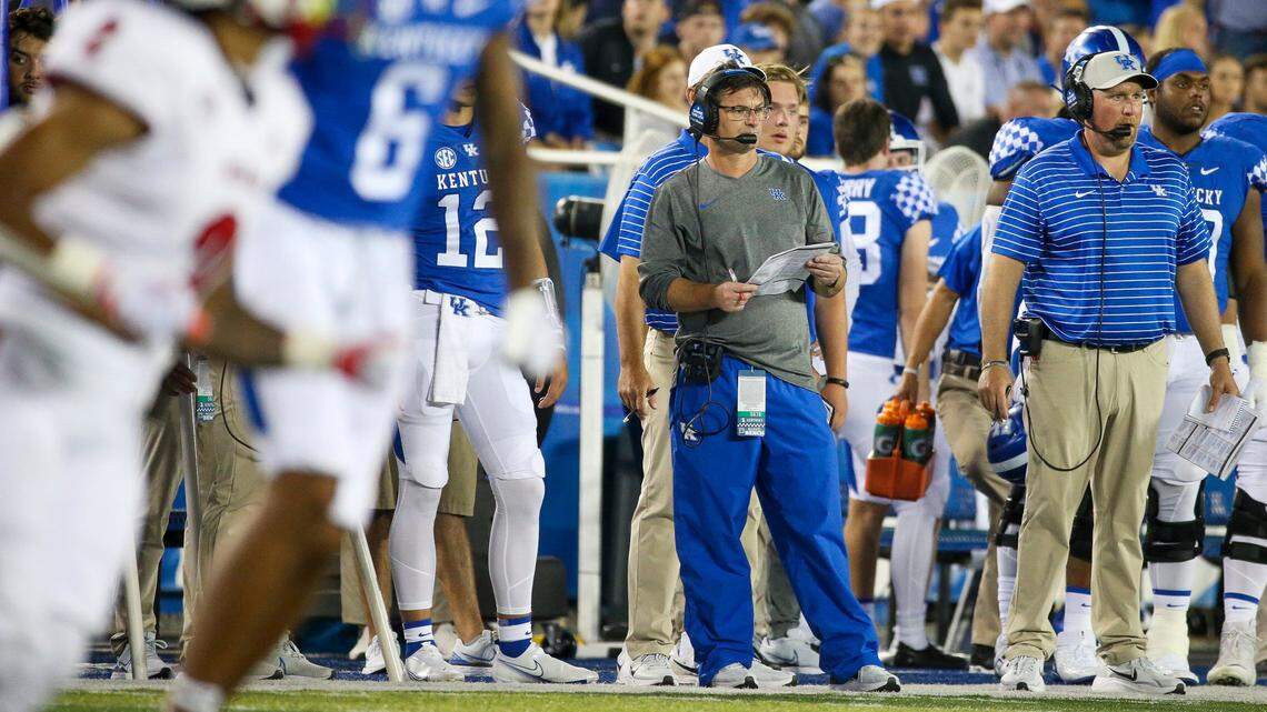 Kentucky offensive coordinator Rich Scangarello, center, and offensive line coach Zach Yenser, right, on the sidelines during the team’s game against Miami (Ohio) on Sept. 3.