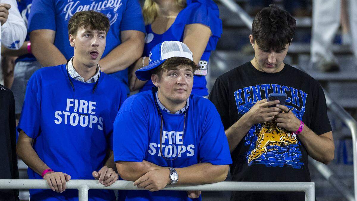 Fans in the student section wear “Fire Stoops” T-shirts during the game against Texas on Saturday at Kroger Field.