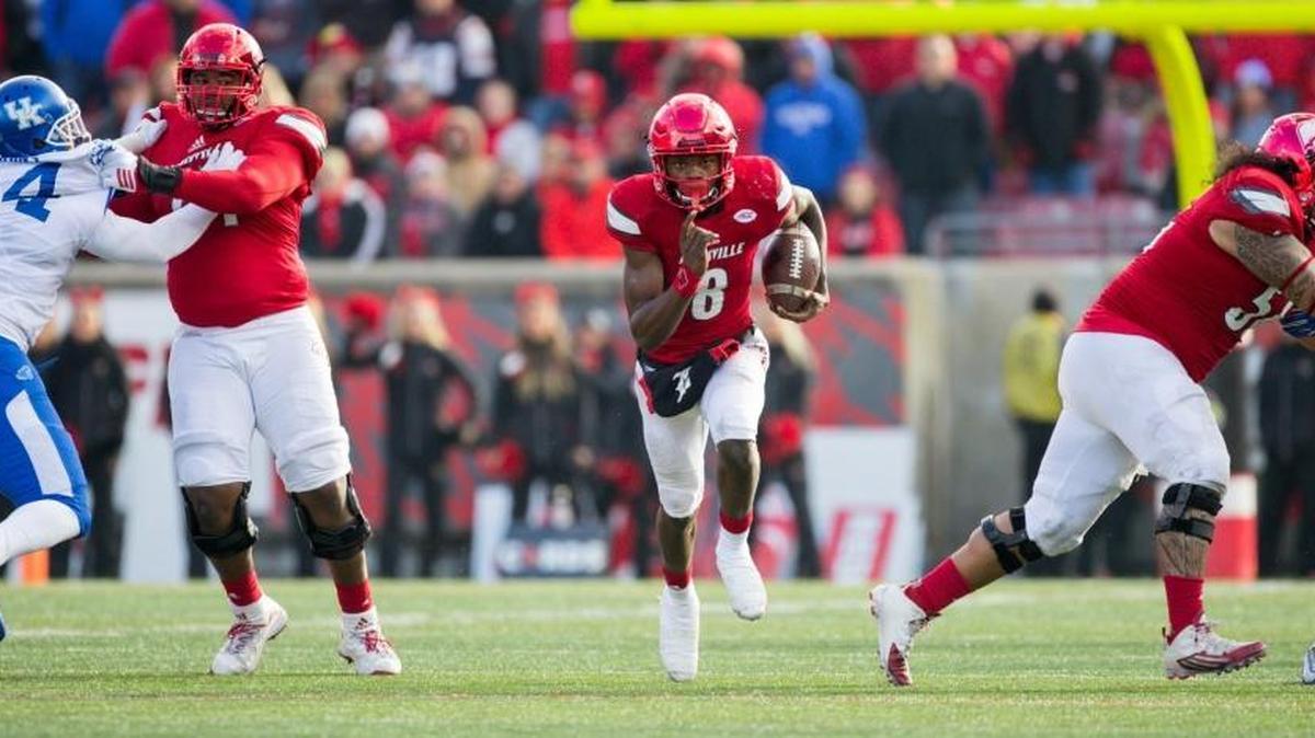 Louisville quarterback Lamar Jackson ran through blockers for yardage in the fourth quarter. The University of Louisville hosted Kentucky, Saturday, Nov. 26, 2016 at Papa John's Cardinal Stadium in Louisville. Kentucky won the game 41-38.