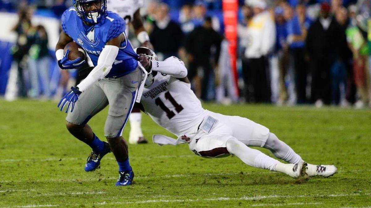 Kentucky Wildcats wide receiver Ryan Timmons (1) pulled in a pass from Patrick Towles over Mississippi State defensive back Kivon Coman as Mississippi State defeated Kentucky 44-31 on October 25, 2014, in Lexington.