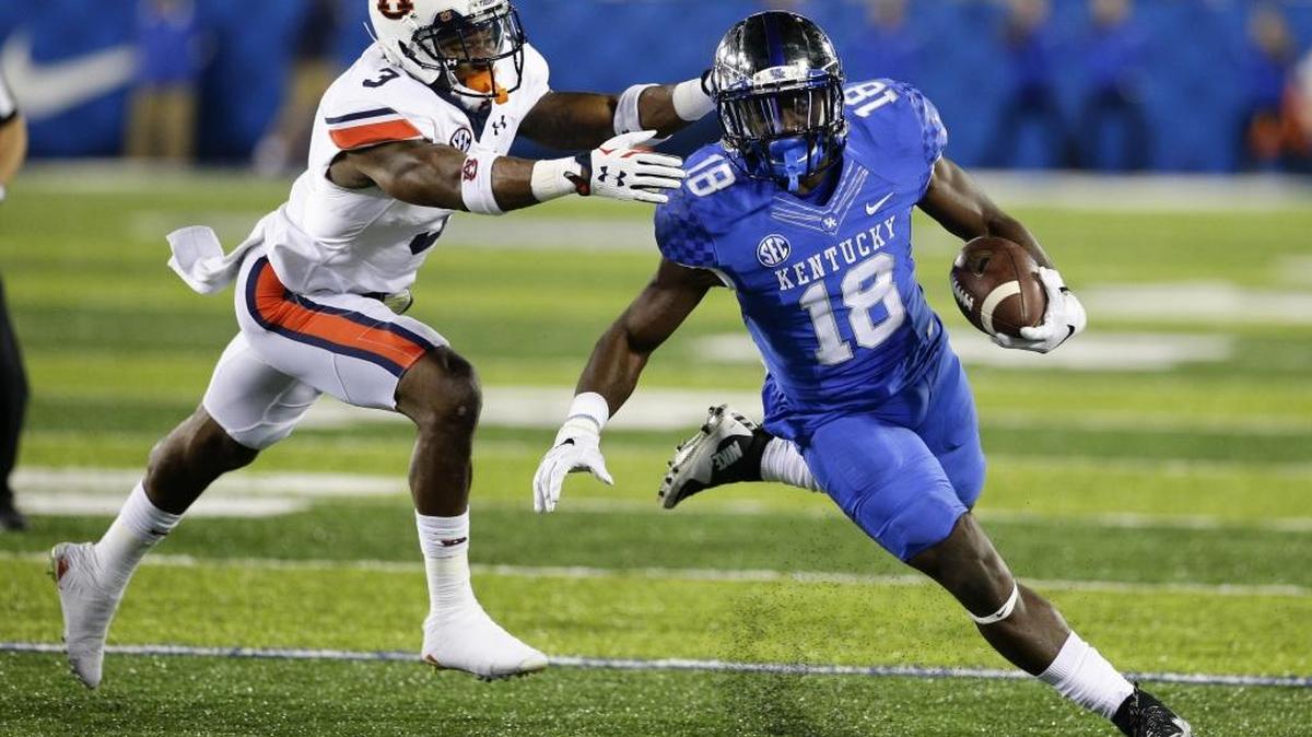 Wildcat running back Boom Williams (18) got around the end on Auburn defensive back Jonathan Jones. Williams scored on the opening drive but the Tigers topped Kentucky 30-27 in that October match.