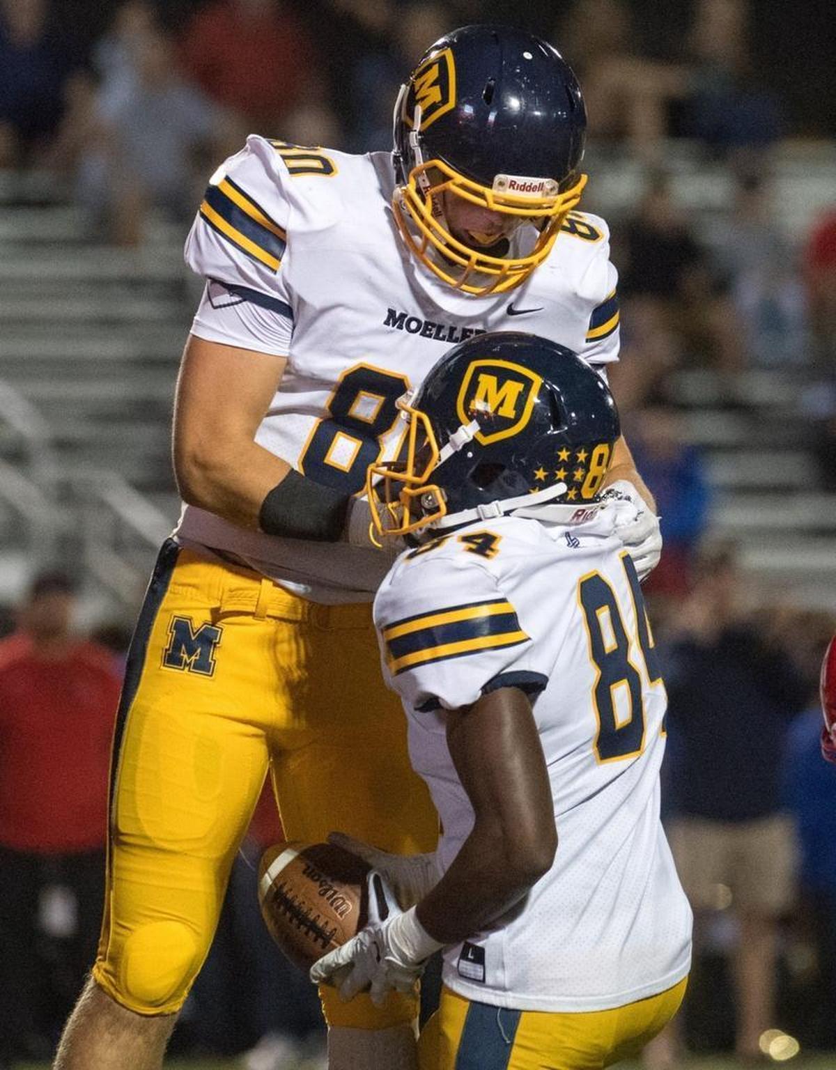Brenden Bates celebrated with a teammate during Moeller’s 38-28 victory over Scott County at Toyota Stadium on Friday night.