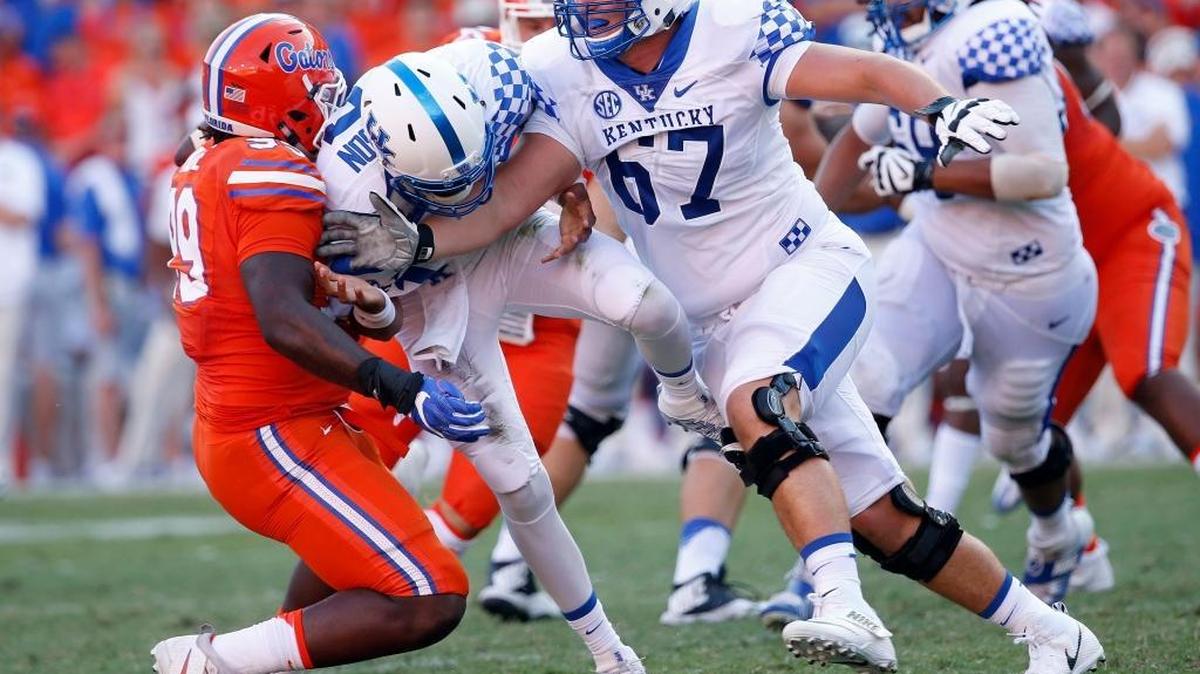 Kentucky offensive lineman Landon Young (67) blocked Florida defensive lineman Jachai Polite (99) as UK quarterback Stephen Johnson, middle, fumbled the ball at Ben Hill Griffin Stadium in Gainesville, Fla., Saturday, September 10, 2016.