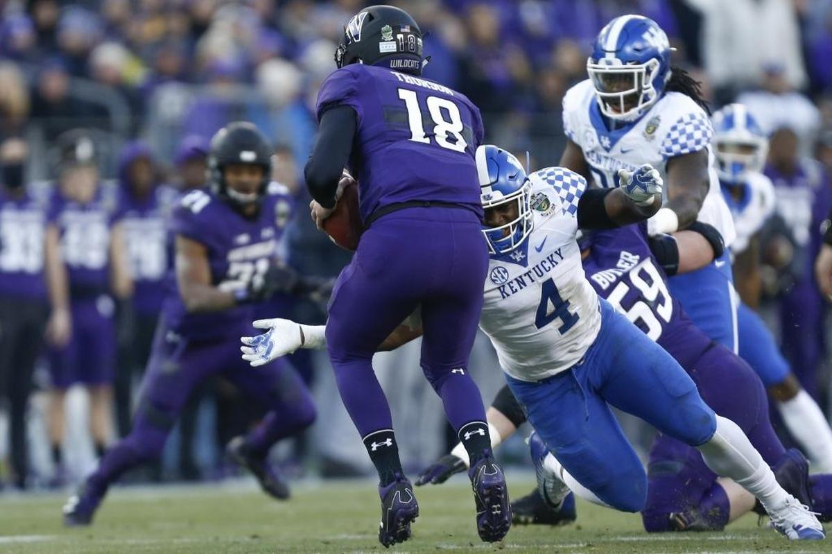Kentucky’s Josh Paschal (4) sacked Northwestern quarterback Clayton Thorson (18) during the first half of UK’s 24-23 loss in last season’s Music City Bowl. Paschal, a sophomore from Olney, Md., is sidelined indefinitely while being treated for a malignant melanoma on his foot.