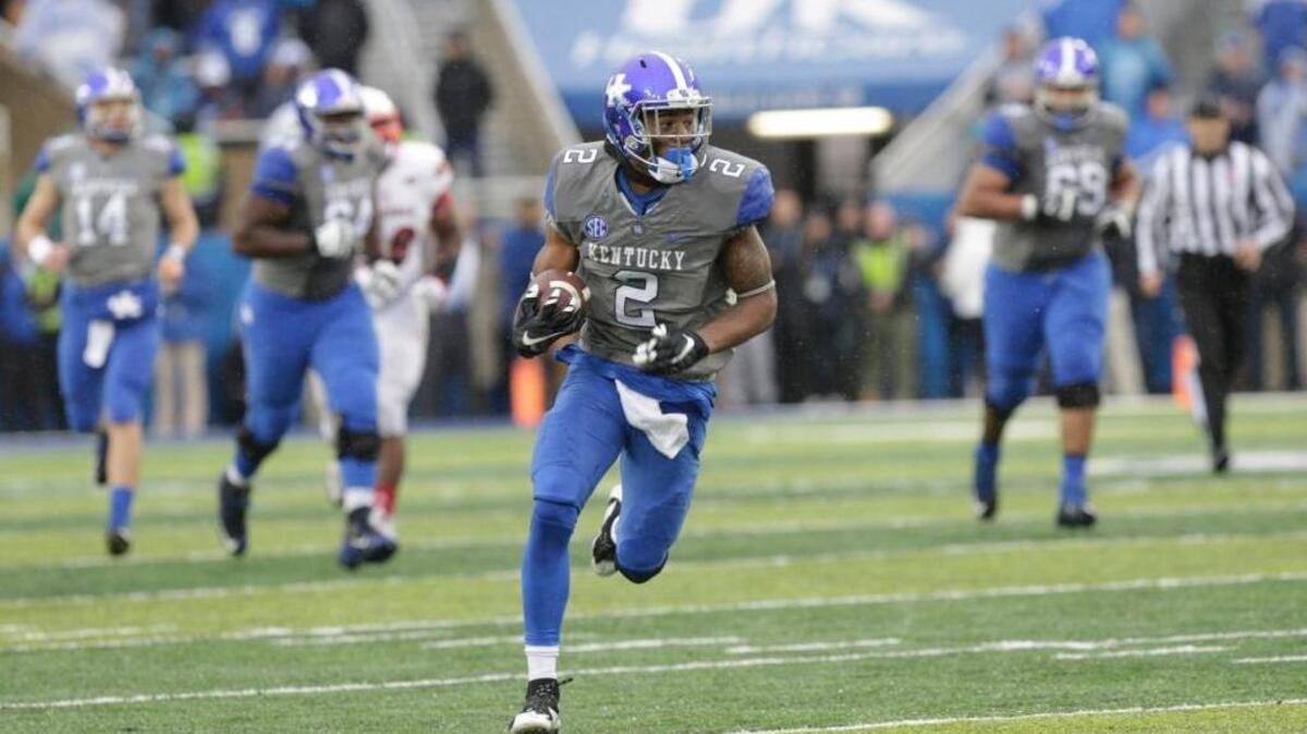 Kentucky wide receiver Dorian Baker (2) on a 53 yard run in the fourth quarter of the Louisville at Kentucky football game at Commonwealth Stadium in Lexington, Ky, on Nov. 28, 2015. Louisville came back in the second half to beat the Wildcats 38-24.