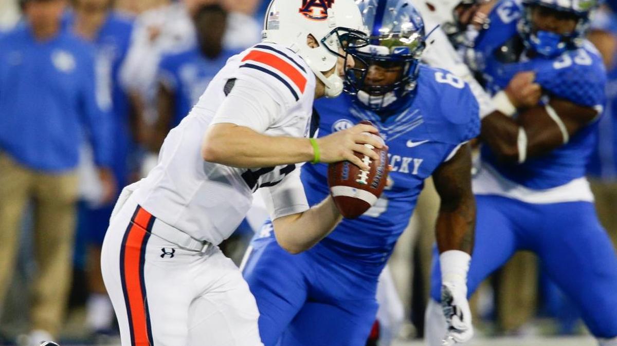 Kentucky Wildcats defensive end Jason Hatcher ,6, putting the pressure on Auburn Tigers quarterback Sean White (13) as Kentucky played Auburn on Thursday October 15, 2015 in Lexington, KY. Photo by Mark Cornelison | Staff