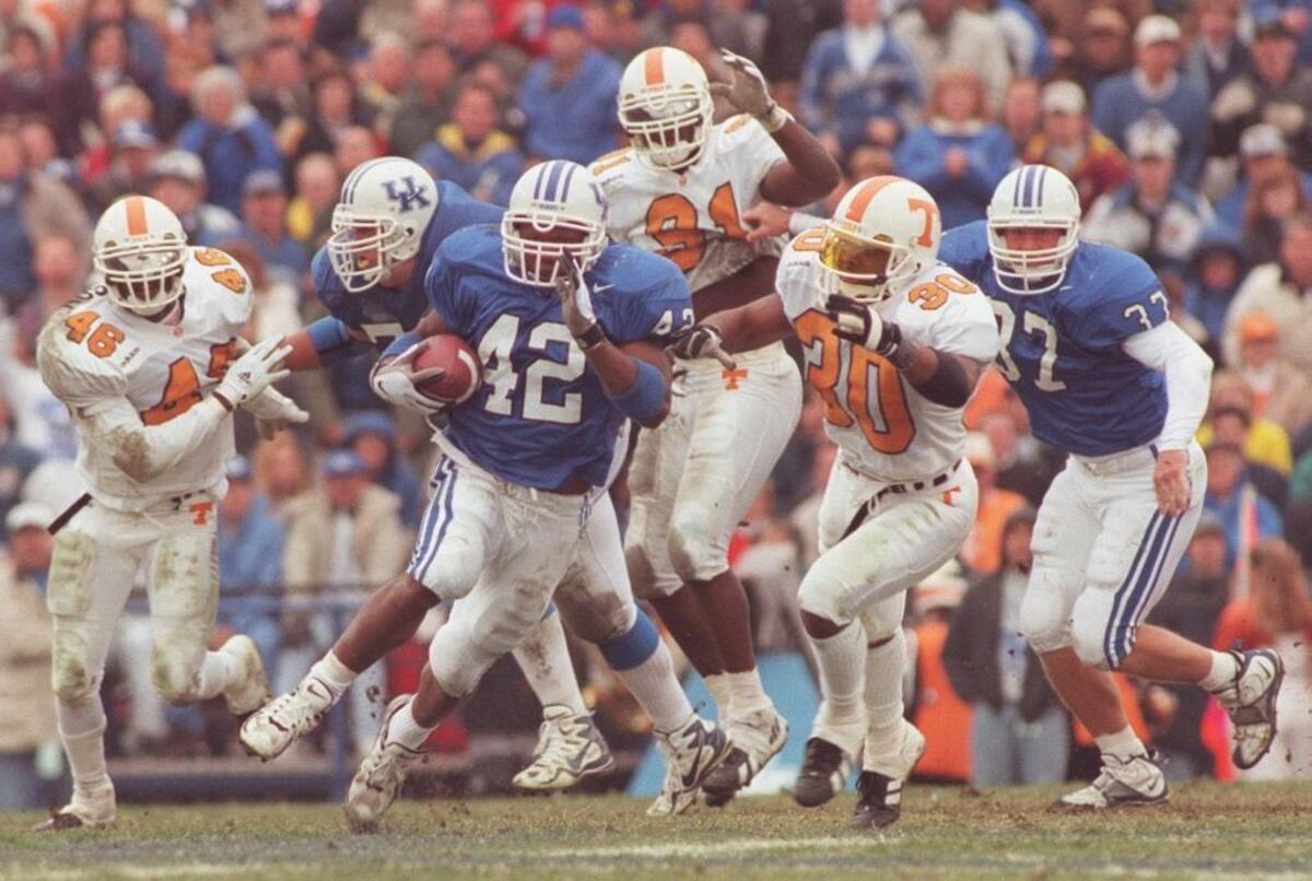 Kentucky running back Derek Homer (42) burst through the Tennessee defensive line on Nov. 22, 1997.