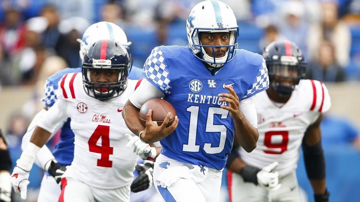 Kentucky quarterback Stephen Johnson (15) ran past Mississippi defensive back C.J. Hampton (4) and defensive tackle Breeland Speaks during Saturday’s game at Kroger Field.