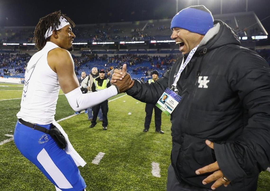 Kentucky quarterback Stephen Johnson celebrated with UKbaseball coach Nick Mingione after Kentucky’s 29-26 win over Tennessee at Kroger Field.